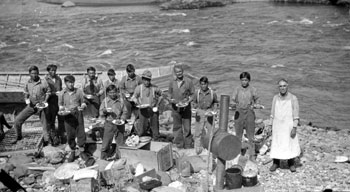 “Some Pelly River snaps. July - 1923 [Del] Van Gorder, Pete [Picard] and the scow crew at Hoole Canyon Ready for lunch.”