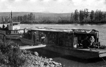 “A few snaps of the Yukon Rose on her first trip up the Pelly - July 1929  At Ross River. Pulling out.” 
