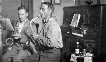 Claude and his buddy and fellow RCMP member Andrew Cruikshank practicing their saxophones in the Tidd home. Claude also took up drums while in Dawson, which required even more rehearsal time away from home.