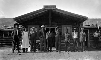 A group of Ross River residents posing outside the Taylor and Drury Post. Claude Tidd is at the extreme left, Pete Picard is to his left, and Del Van Gorder is sixth from left. 1923