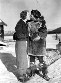 “Off on Patrol” R.C.M.P. Constable Joe Kessler kissing his wife, Lillian, goodbye as he leaves on patrol. ca. 1938