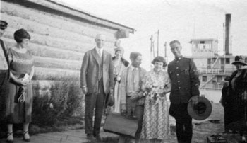 Claude and Mary on their wedding day, perhaps with the Burkes. The S.S. Yukon is in the background. The steamer and her crew played a large role in the Tidds' wedding day.
