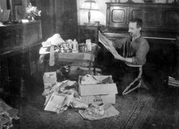 Claude opens his Christmas boxes in Mayo, 1933. Mary spent this Christmas in England with Claude's parents.