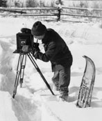 The intrepid photographer sets his camera up in the snow. Note the pipe, which seems to be present in more photos of Claude than not!