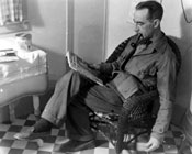 Claude creating a self-portrait in his Mayo kitchen. His hand is near the floor, pushing a button to take the photo. 